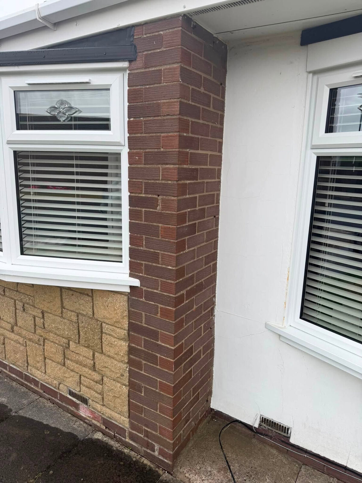 Neatly finished red-brick pier beside a bay window